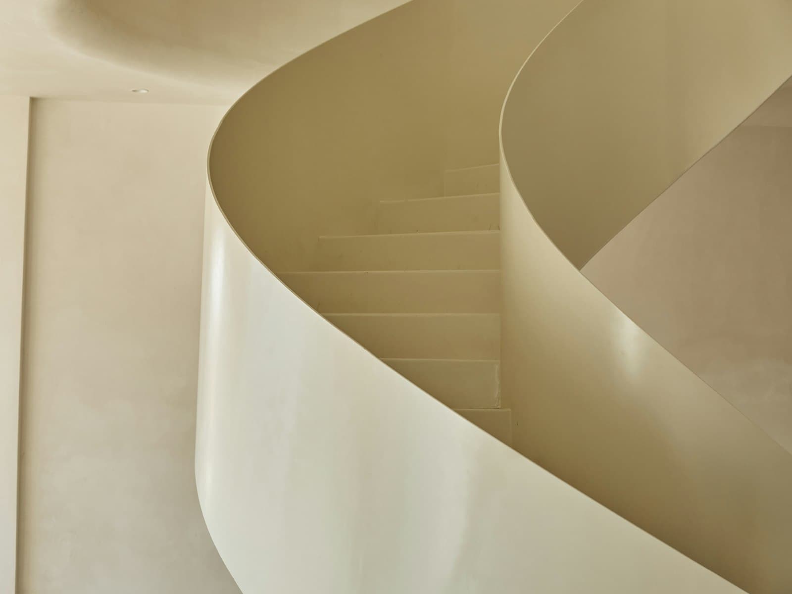 A curved staircase turning upward out of sight.